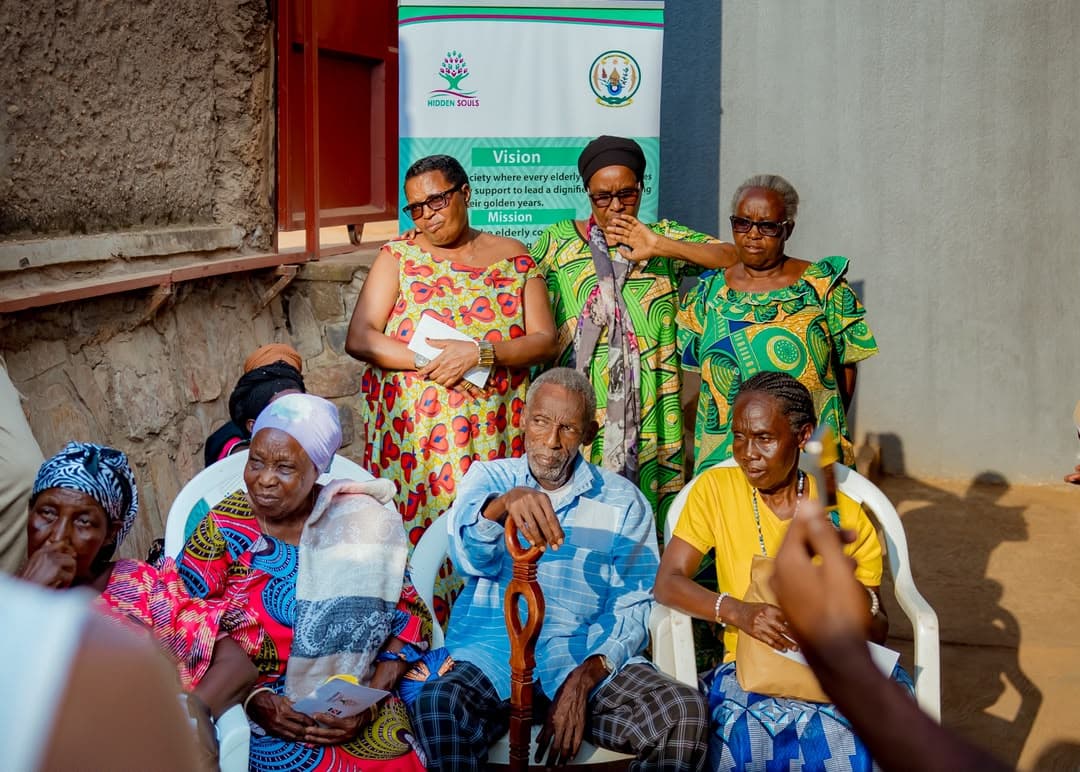 Hidden Souls team and elders gathered beside the organisation banner