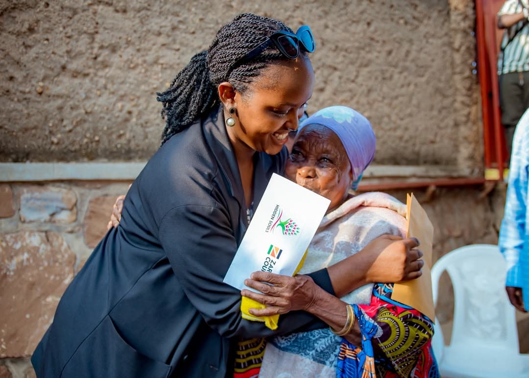 A Hidden Souls leader embracing an older woman during a support handover